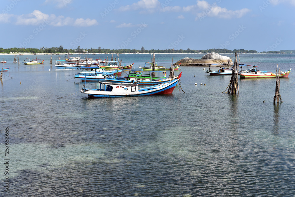 Traditional small fishing boats at the western side of Tanjung Kelayang Beach in Belitung Island, Indonesia