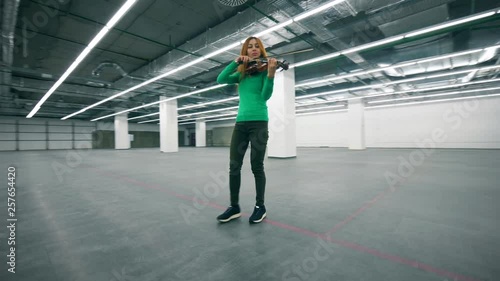 Violin player performing in an empty offcie room. photo