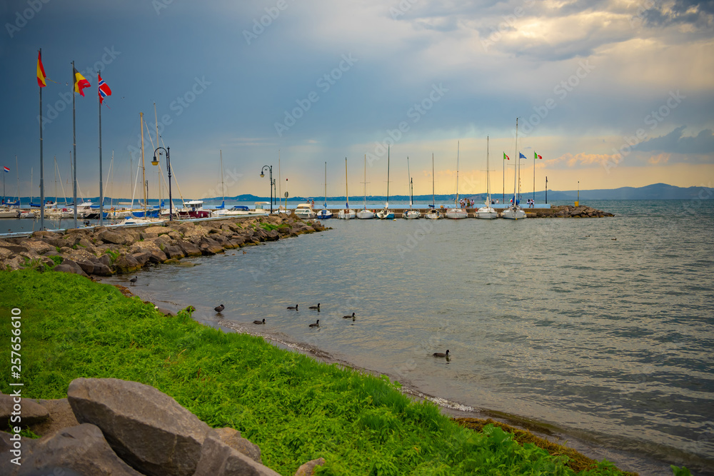 Boats in harbor. The lake Bolsena in a stormy day, Provincia di Viterbo, Italy.  Lago di Bolsena.