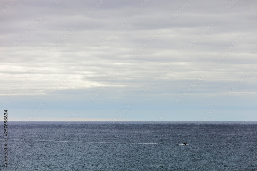 Speedboat sailing across open ocean water.