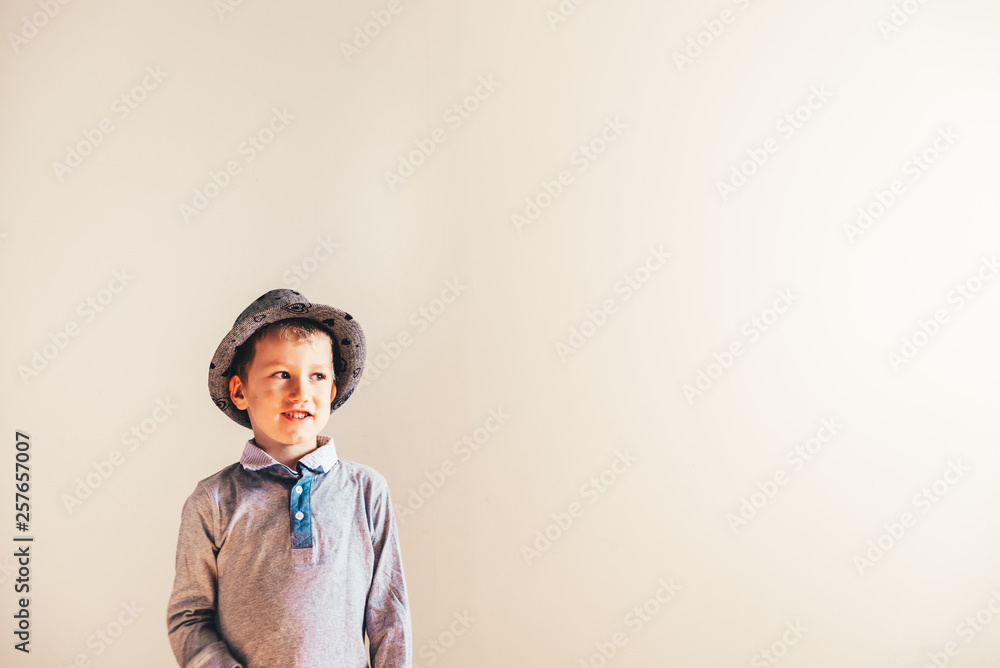 Nice boy playing with a hat, blank background. Nice boy playing with a hat, blank background.