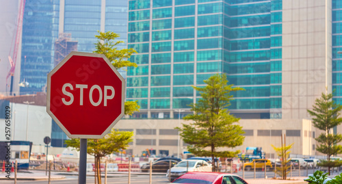 stop sign on the road in city with modern buildings background photo
