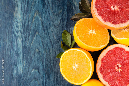 Citrus fruit. Different citrus fruits with leaves of lemon, orange, grapefruit on a blue wooden table. top view