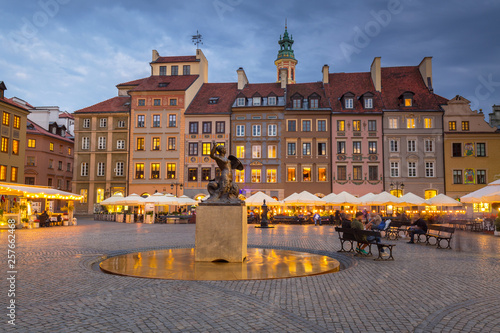 Statue of mermaid in Warsaw old town at dusk, Poland photo