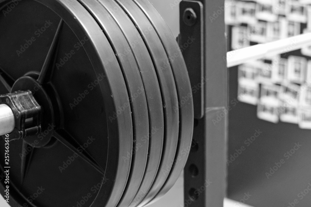 Barbell with black plates. Balck and white close up image Barbell with black plates. Balck and white close up image