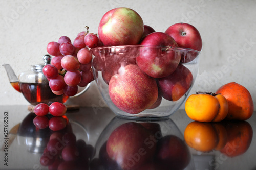 Glass vase with ripe fruit on the table