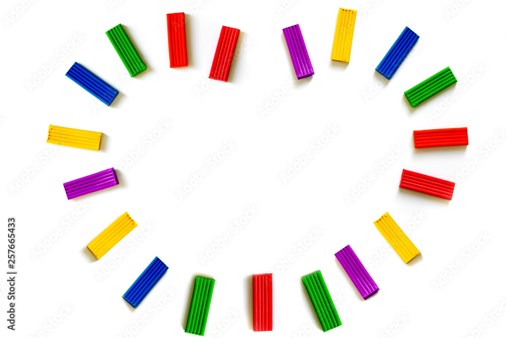 Multi-colored plasticine different shapes on a white background. How to organize classes with children at home. Motor development. Development of children's hands. Concept of education. Multi-colored plasticine different shapes on a white background. How to organize classes with children at home. Motor development. Development of children's hands. Concept of education.