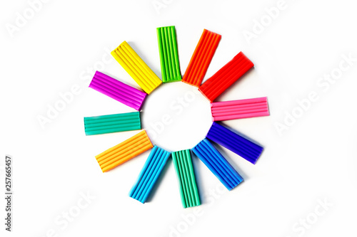 colored plasticine in the shape of a flower on a white background. How to organize classes with children at home. Motor development. Development of children's hands. Concept of education.