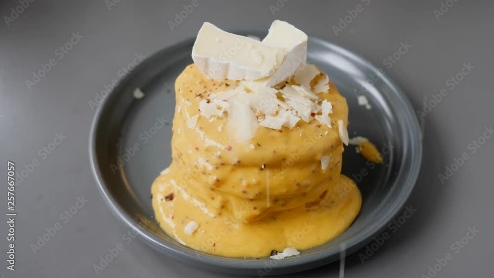 Making cooking pancakes dish putting on them diverse toppings using sauces and other ingredients Making cooking pancakes dish putting on them diverse toppings using sauces and other ingredients