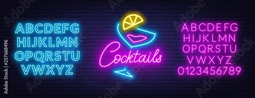 Neon lettering cocktails on brick wall background. Neon fonts.