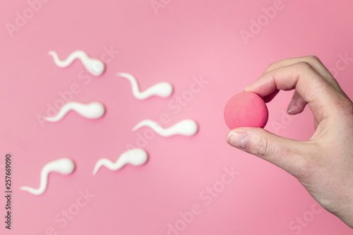 Sperm swimming toward egg concept. photo
