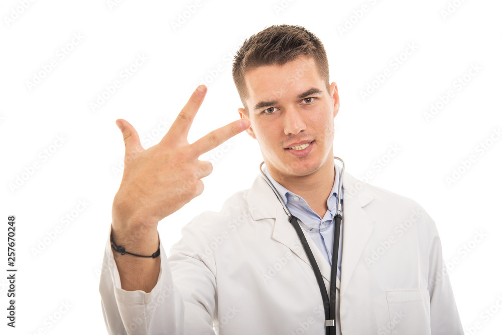 Portrait of young handsome doctor showing number three gesture Portrait of young handsome doctor showing number three gesture