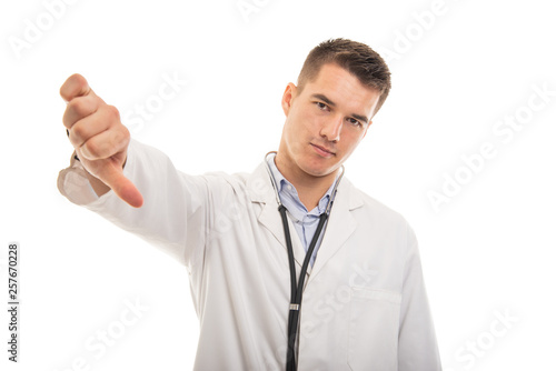 Portrait of young handsome doctor showing dislike gesture