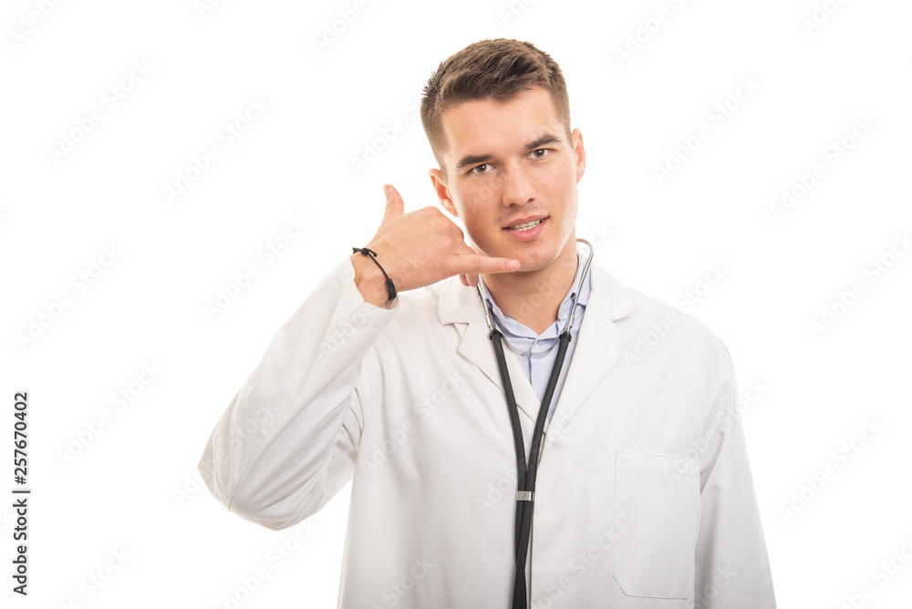 Portrait of young handsome doctor making contact gesture Portrait of young handsome doctor making contact gesture