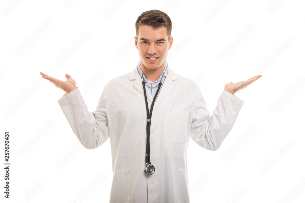 Portrait of young handsome doctor showing copy space Portrait of young handsome doctor showing copy space