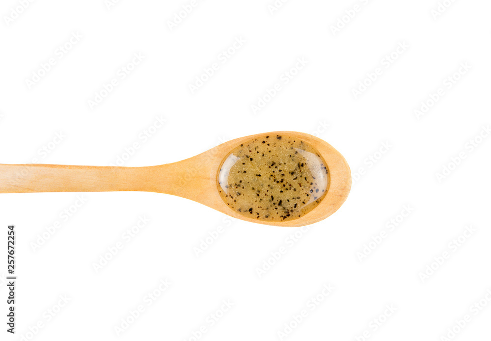 Scrubbing honey and coffee mixture on body in hot sauna helps open the pores and renew, rejuvenate the skin on body. Sauna treatment. Wooden spoon with sauna honey isolated on white background. Scrubbing honey and coffee mixture on body in hot sauna helps open the pores and renew, rejuvenate the skin on body. Sauna treatment. Wooden spoon with sauna honey isolated on white background.