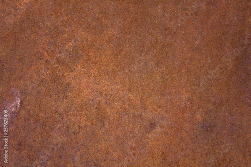 brown rusty metal sheet with blue dots. rough surface texture