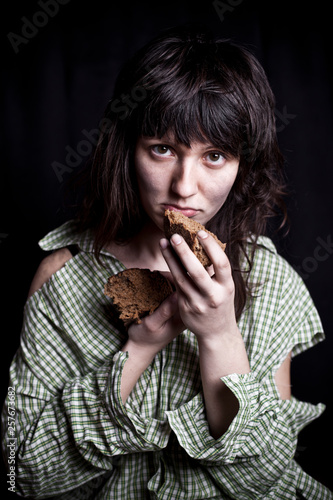 Poor beggar woman with a piece of bread.