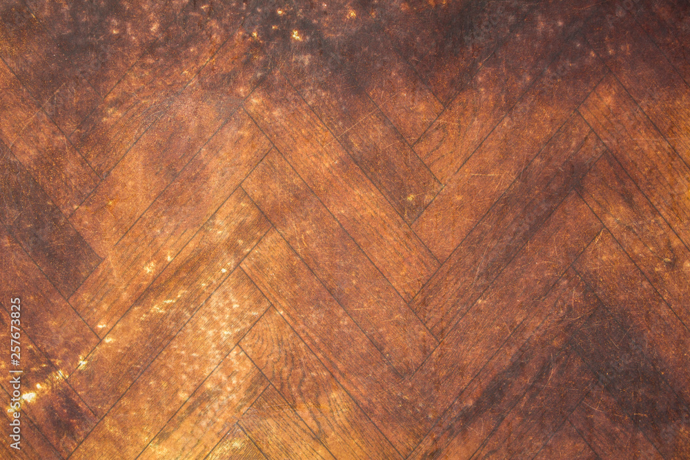 old yellow parquet with brown dirt stains and scratches. rough surface texture