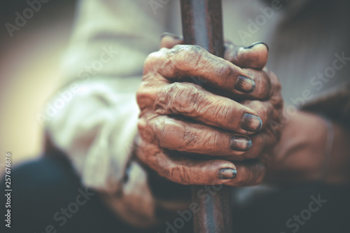 Dirty hands of farmers,close up dirty hands holding wood,Dirty hands from work,Old people with skin withered, © CStock