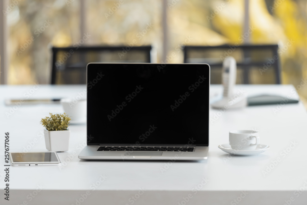 Laptop mockup with tablet computer, tablet and cup of coffee on the modern office working desk. Laptop mockup with tablet computer, tablet and cup of coffee on the modern office working desk.
