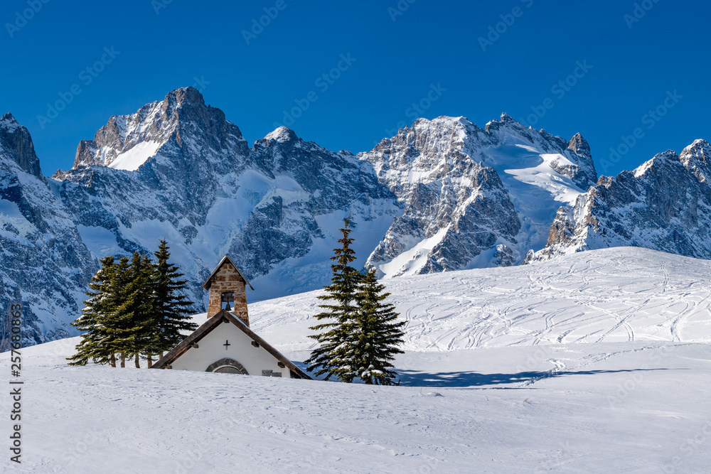 Col du Lautaret, Hautes-Alpes, Ecrins National Park, Alps, France: Winter view on the glaciers and mountain peaks (Gaspard Peak and La Meije) with La Chappelle des Fusillés