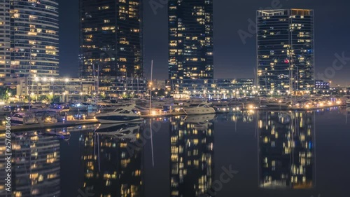 Wallpaper Mural Timelapse of modern part of Melbourne, Australia, with luxurious apartment blocks at night. Perfect reflection in the calm waters of the canal with parked luxurious yachts. Torontodigital.ca