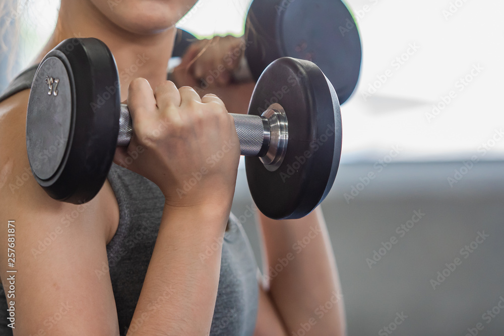 Female doing weight exercise for legs by Inner Thigh Machine in the sports gym, bodybuilder concept. Female doing weight exercise for legs by Inner Thigh Machine in the sports gym, bodybuilder concept.