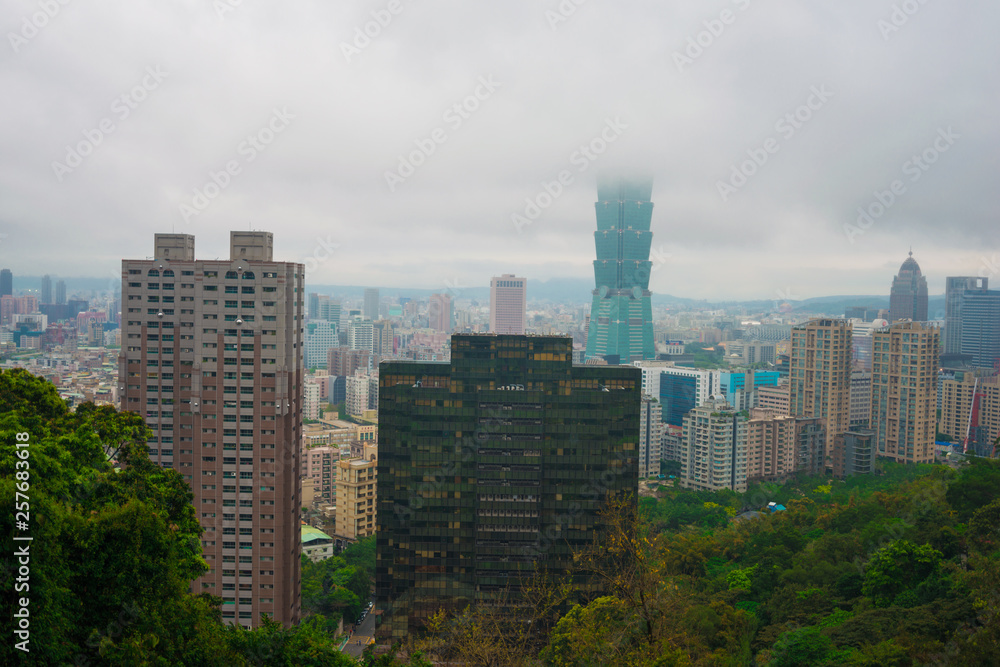 Taipei 101 modern city building with cloud rain at dusk