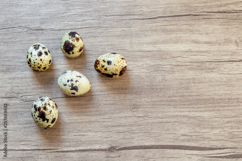 Quail eggs on brown wooden background. Flat lay, top view. Easter concept. Quail eggs on brown wooden background. Flat lay, top view. Easter concept.
