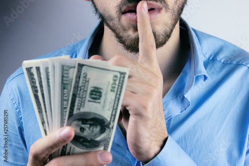 Photography Bribery people with dollar bills in hand and quiet gesture