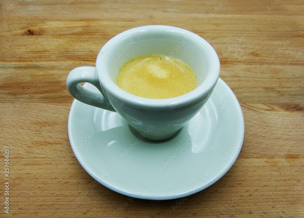 Espresso, traditional italian coffee in white ceramic cup with saucer Espresso, traditional italian coffee in white ceramic cup with saucer