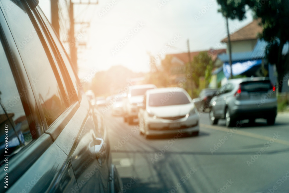 The view is reflected from the car side glass, which has cars that run on the road during the daytime to do business or travel.