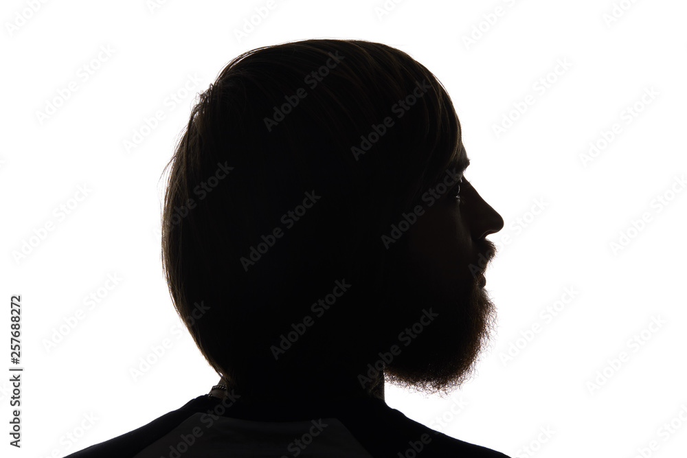 Silhouette of man with beard looking away isolated on white