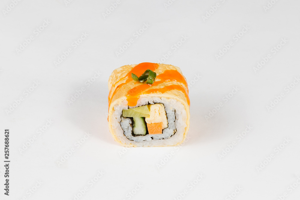 The concept of Japanese and Chinese cuisine. Sushi roll with scrambled eggs and avocado The concept of Japanese and Chinese cuisine. Sushi roll with scrambled eggs and avocado