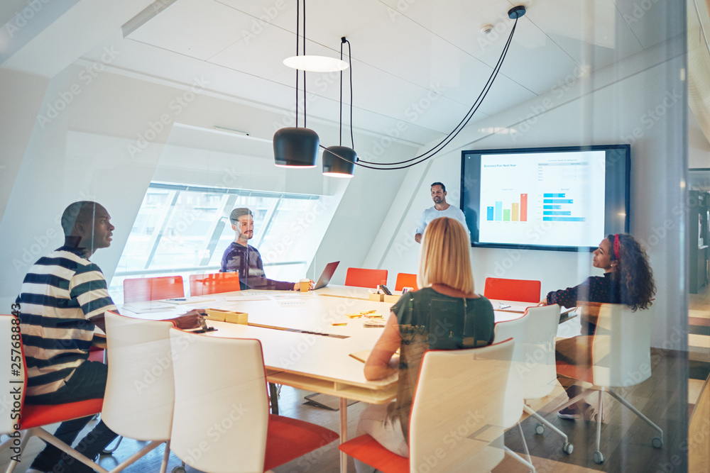 Diverse group of colleagues talking together during an office pr