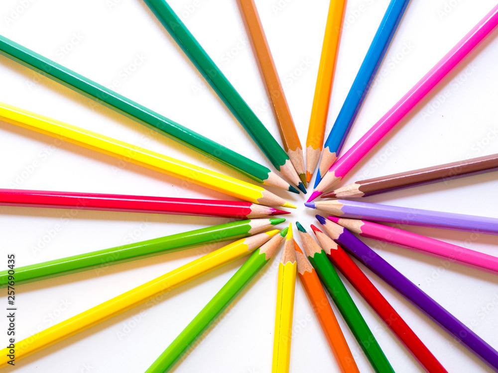 Colour pencils in circle form on white paper background as a background. Colour pencils in circle form on white paper background as a background.