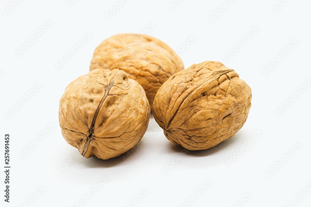 Three whole walnuts isolated on white background Three whole walnuts isolated on white background