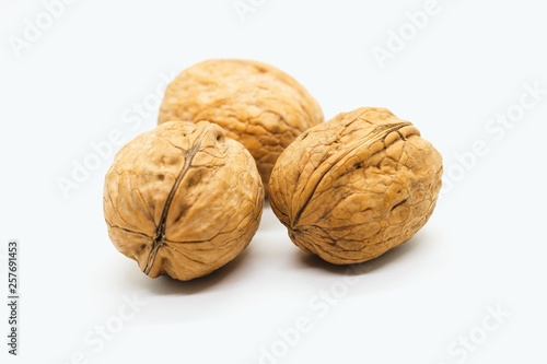 Three whole walnuts isolated on white background