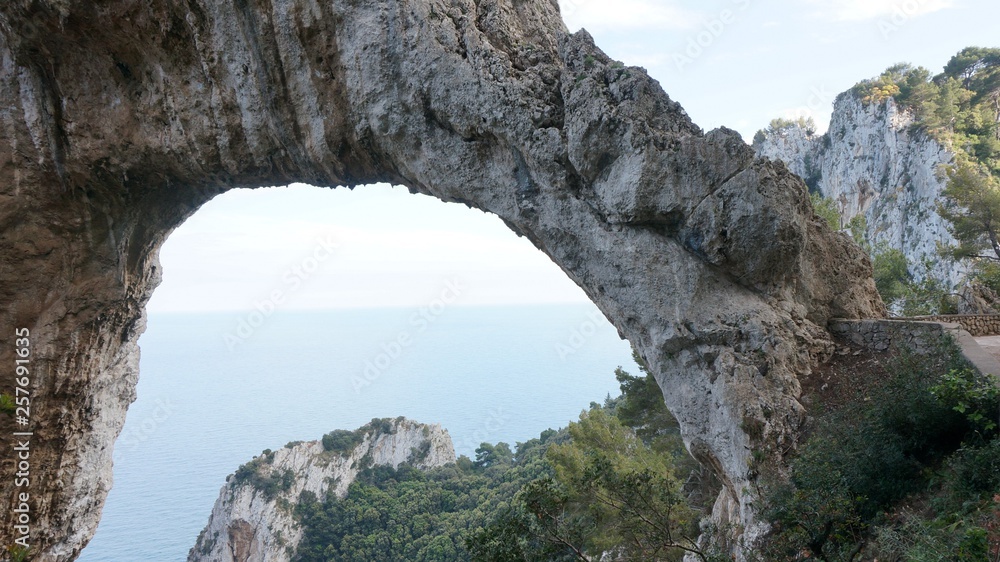 Hole in a rock, cliff on a hiking path at the mediterranean coast of capri