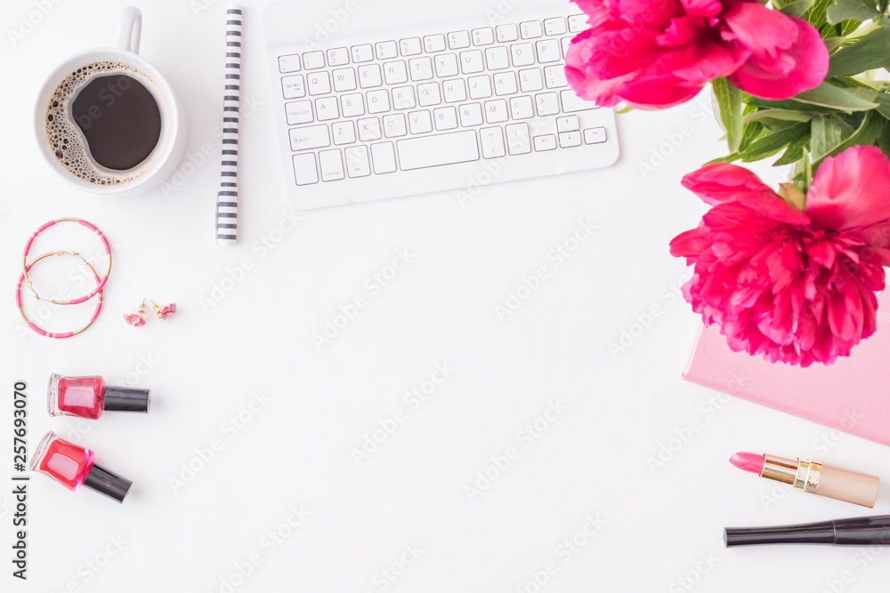 Flat lay blogger or freelancer workspace with a notebook, keyboard, red peonies on a white background Flat lay blogger or freelancer workspace with a notebook, keyboard, red peonies on a white background