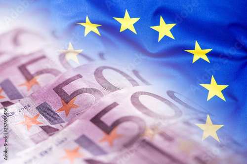 Colorful waving european union flag on a euro money background