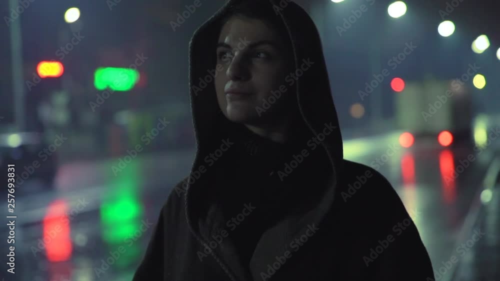 Portrait of young attractive hipster girl standing along the road under the rain. Female traveling Portrait of young attractive hipster girl standing along the road under the rain. Female traveling