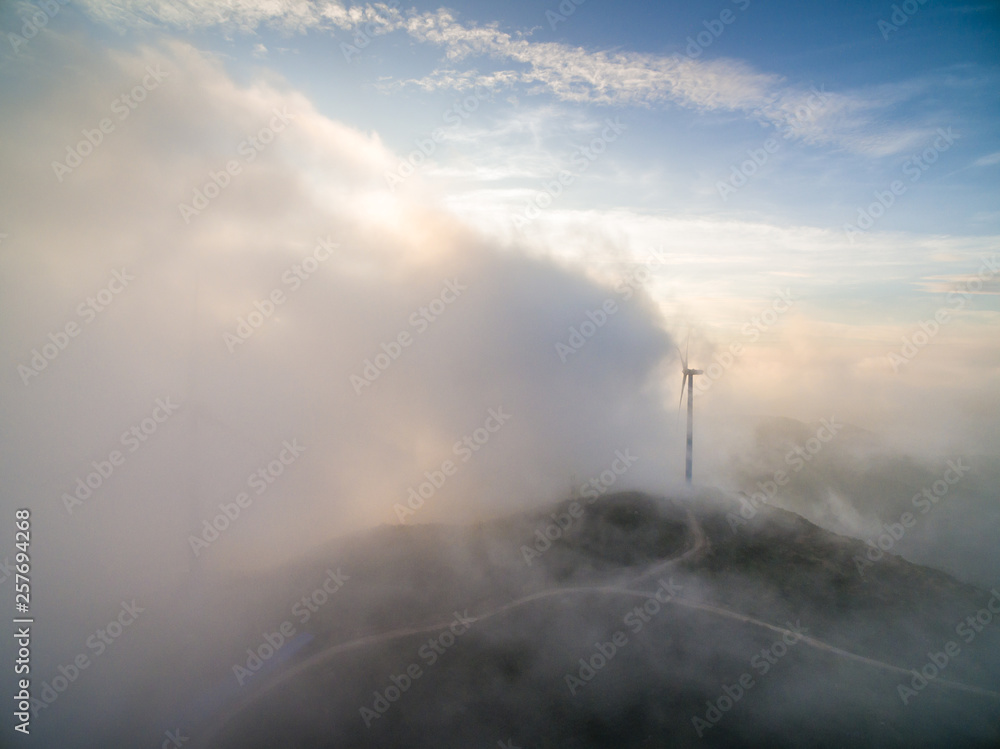 Wind power generator before sunrise sunset ，Wind power generation in the sea of clouds