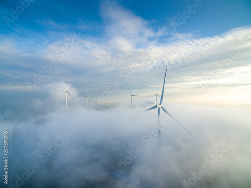 Wind power generator before sunrise sunset ，Wind power generation in the sea of clouds