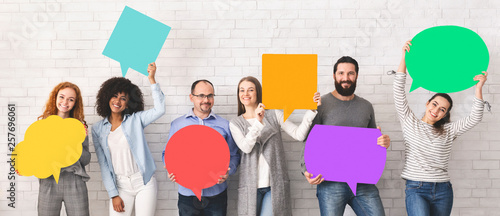 Group of diverse people holding colorful speech bubbles photo