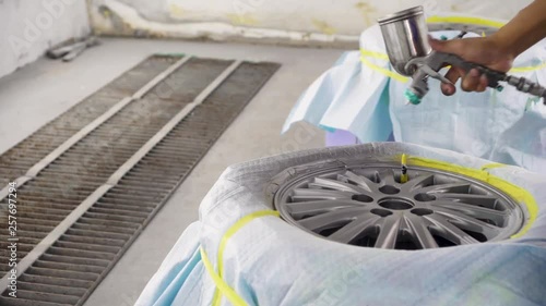 Wheel repair ,Automobile disc restoring. Painter painting light alloy wheel with spray