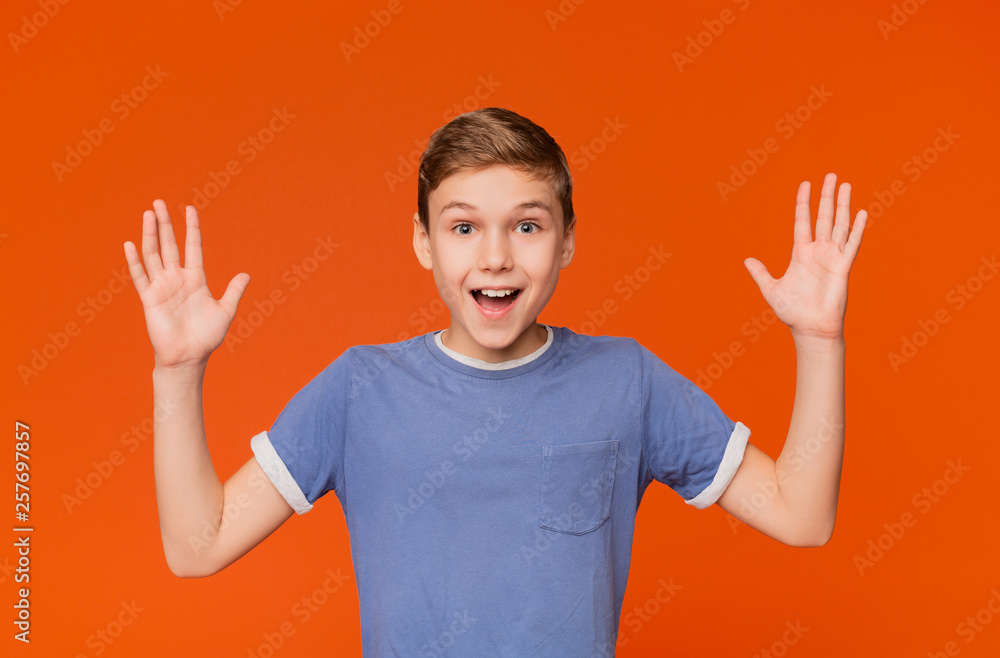 Joyful boy enjoying something, raising hands and screaming Joyful boy enjoying something, raising hands and screaming