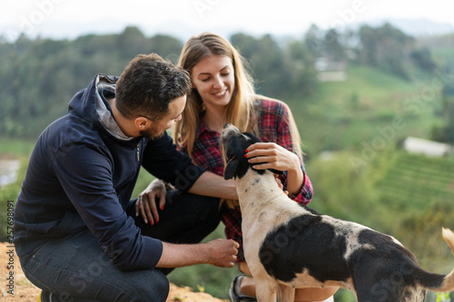 couple in love with a dog in the mountains