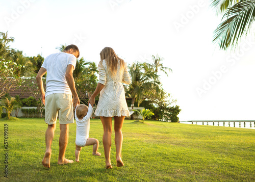 Family walk in the park, happy at sunset in Samui, Thailand